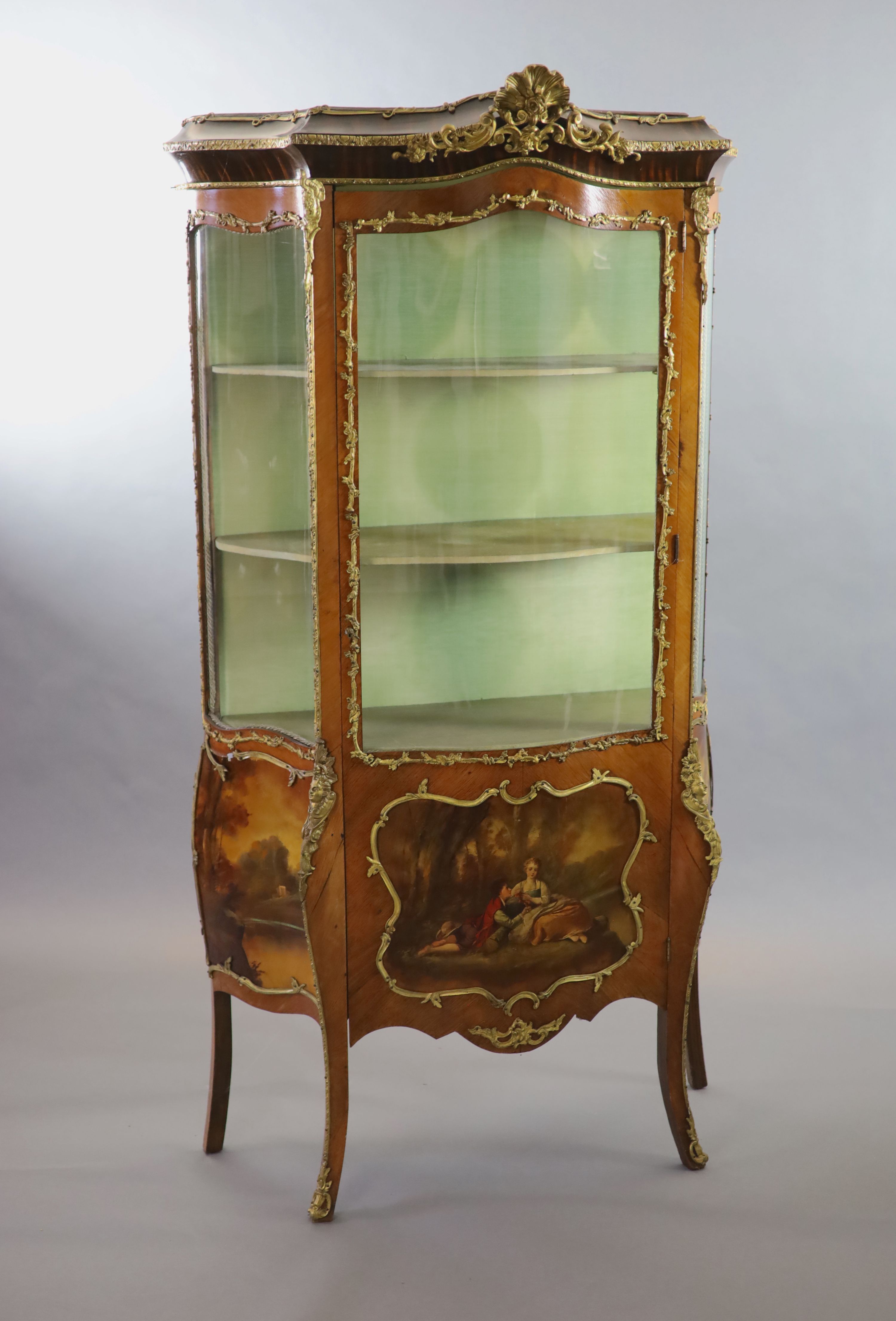 A Louis XV style mahogany vitrine, 76cm wide, 38cm deep, 194cm high.